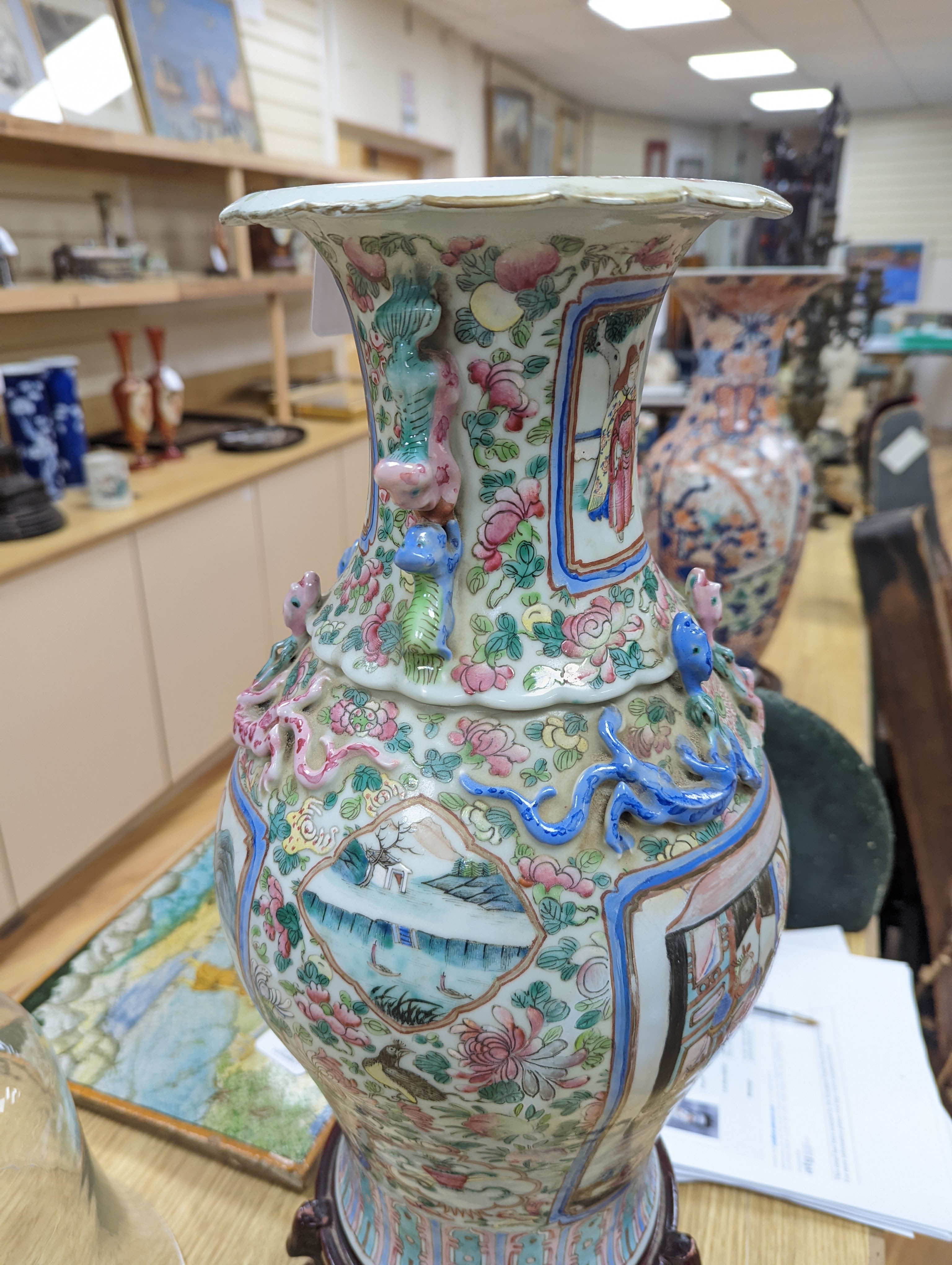 A large Chinese famille rose two handled vase, late 19th century, wood stand, restored 54cm incl stand